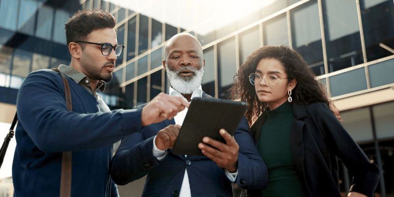 group of business executives discussing legal strategy and managed IT services on a tablet