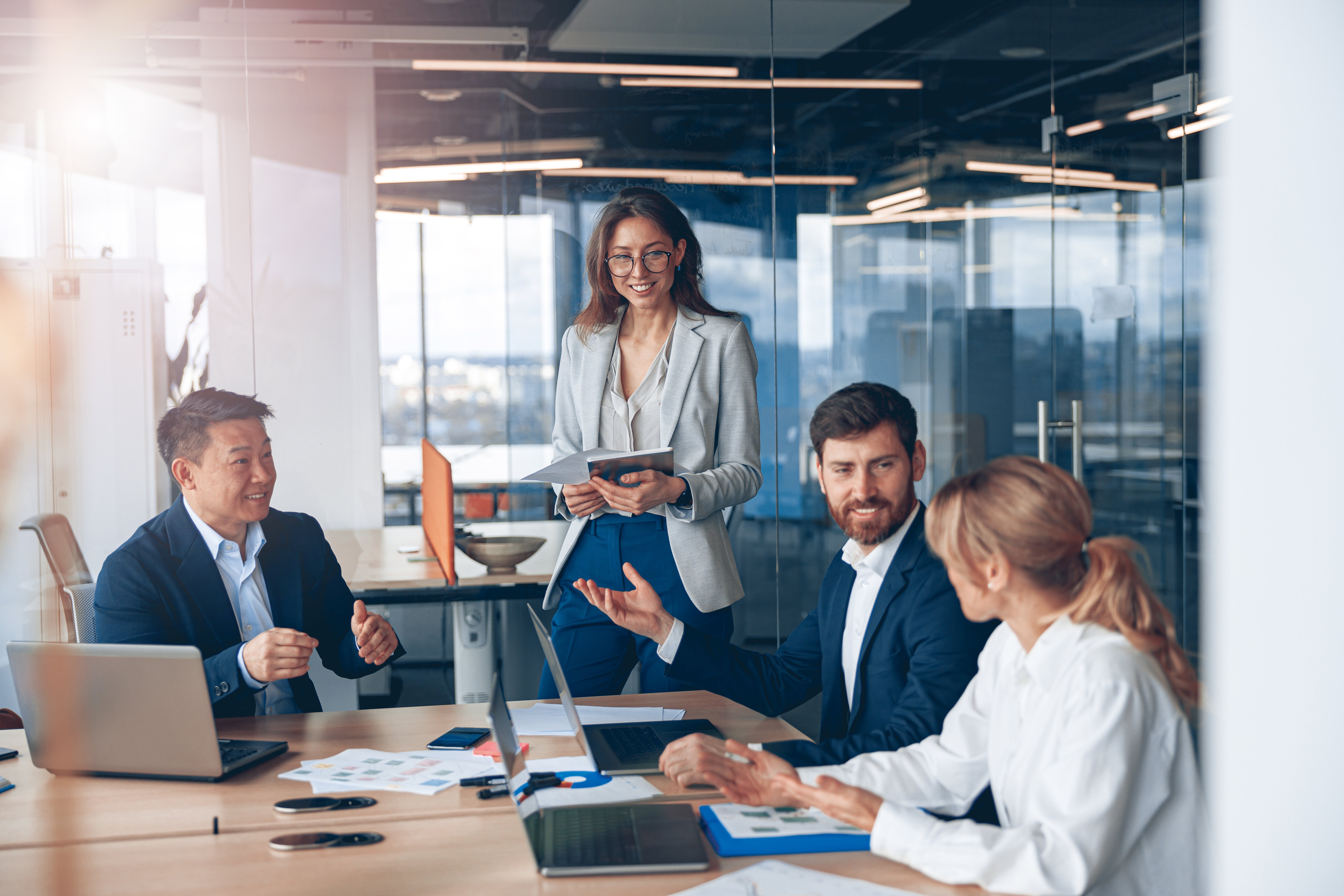 Professional business employees meeting in a glass conference room