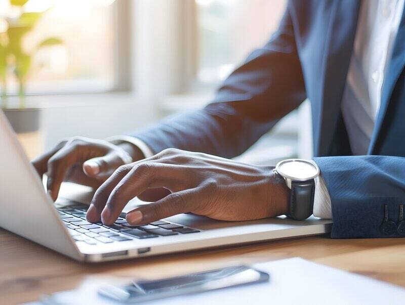 man typing on laptop