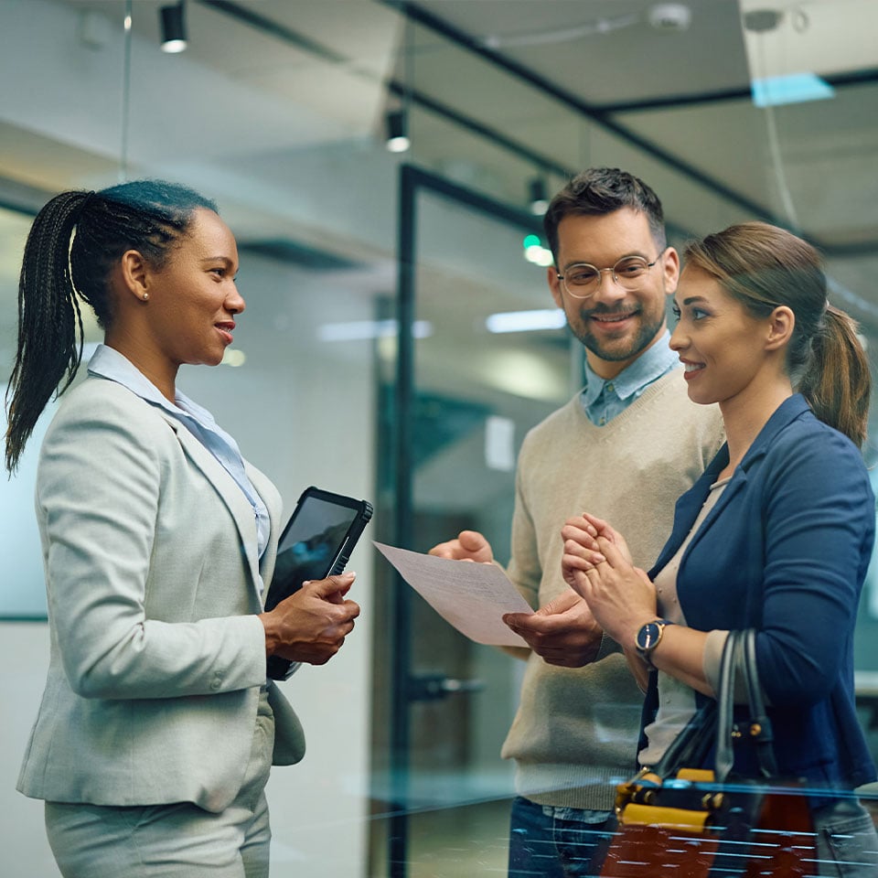 Co-workers discussing business holding technology